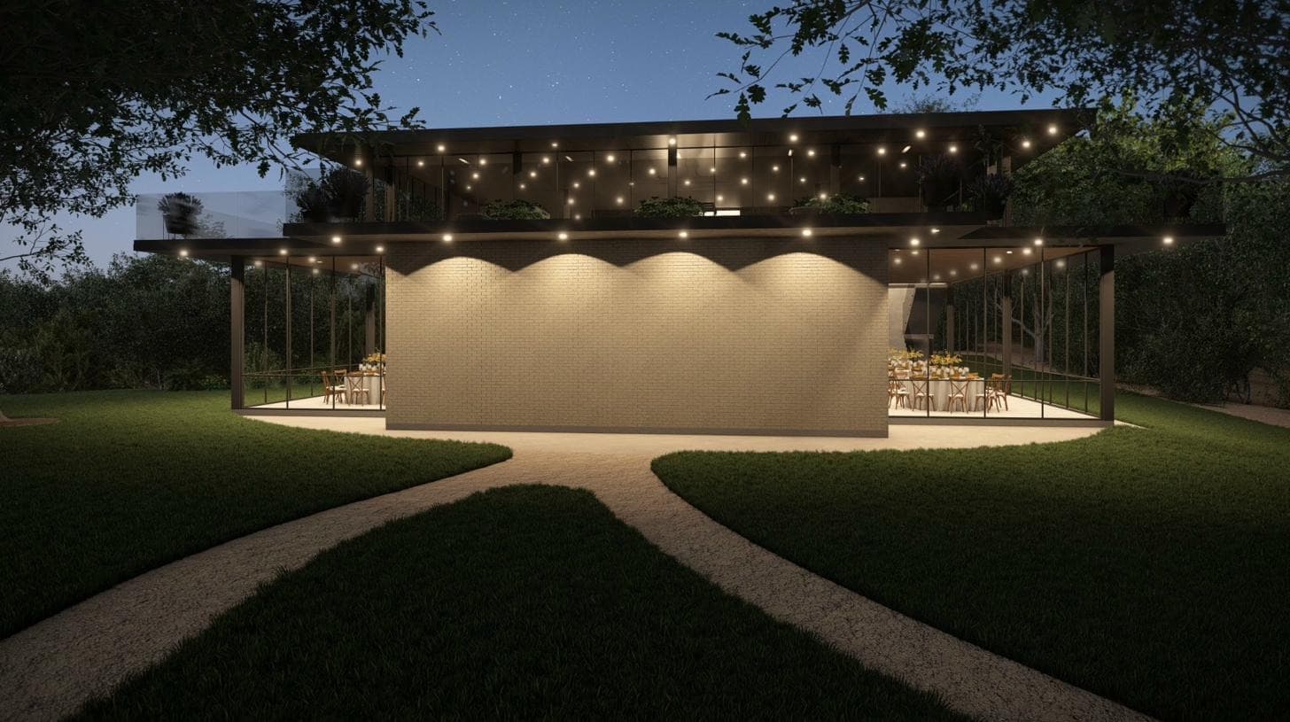 Glass House at night, exterior glowing beneath string lights