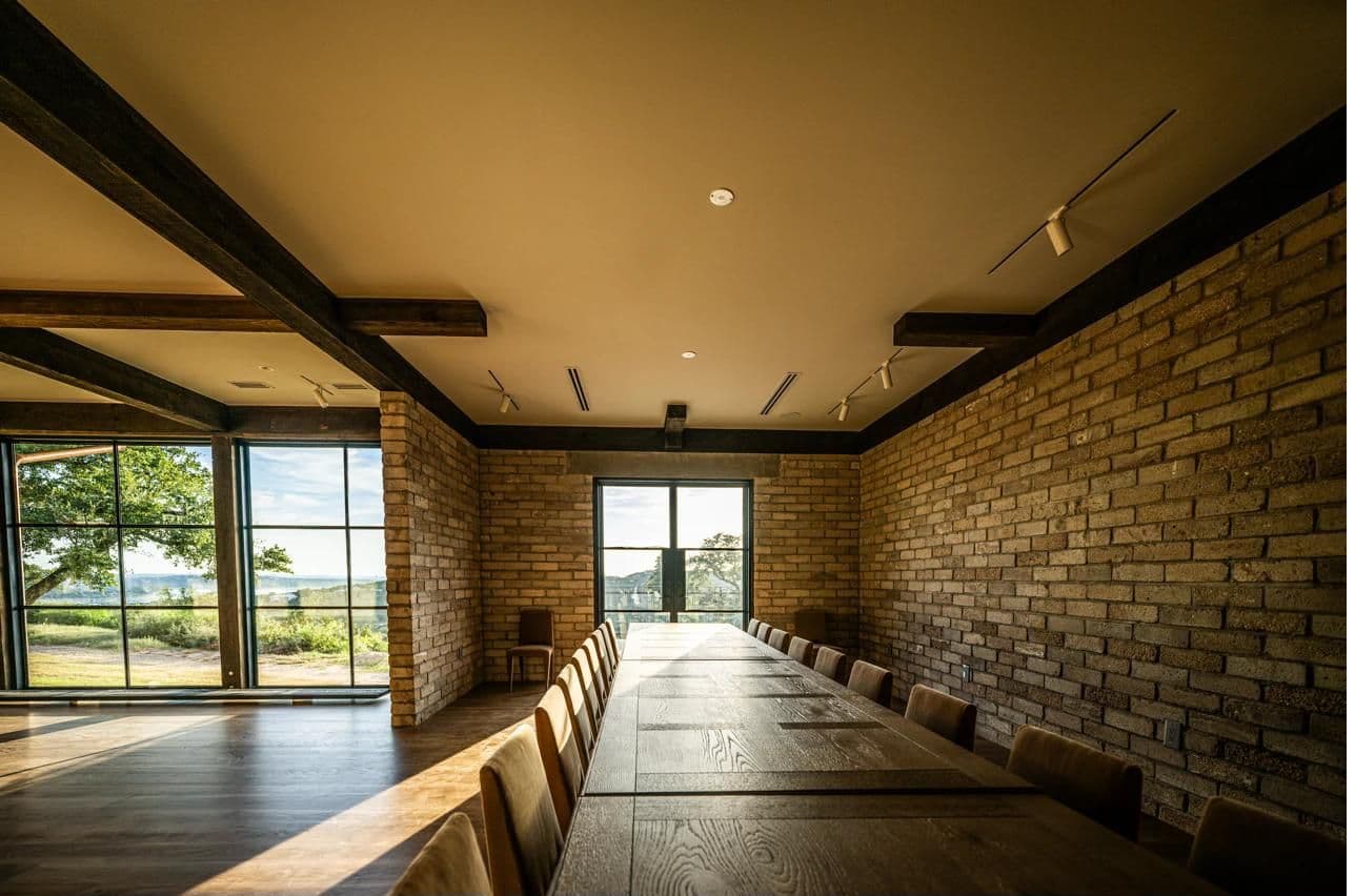 Luna Manor boardroom table with Lake Travis view — setup for an offsite