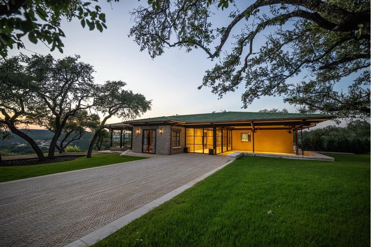 Luna Manor at dusk with warm interior glow — evening event