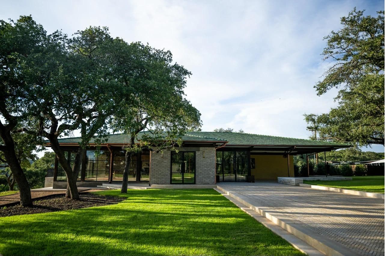 Luna Manor front entry with brick walkway and oaks