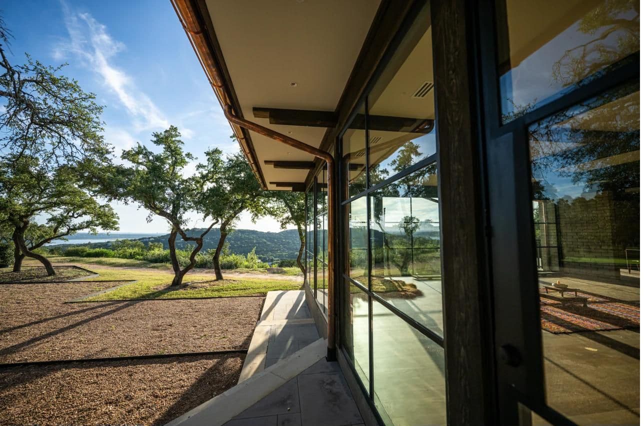 Luna Manor glass facade reflecting Lake Travis landscape