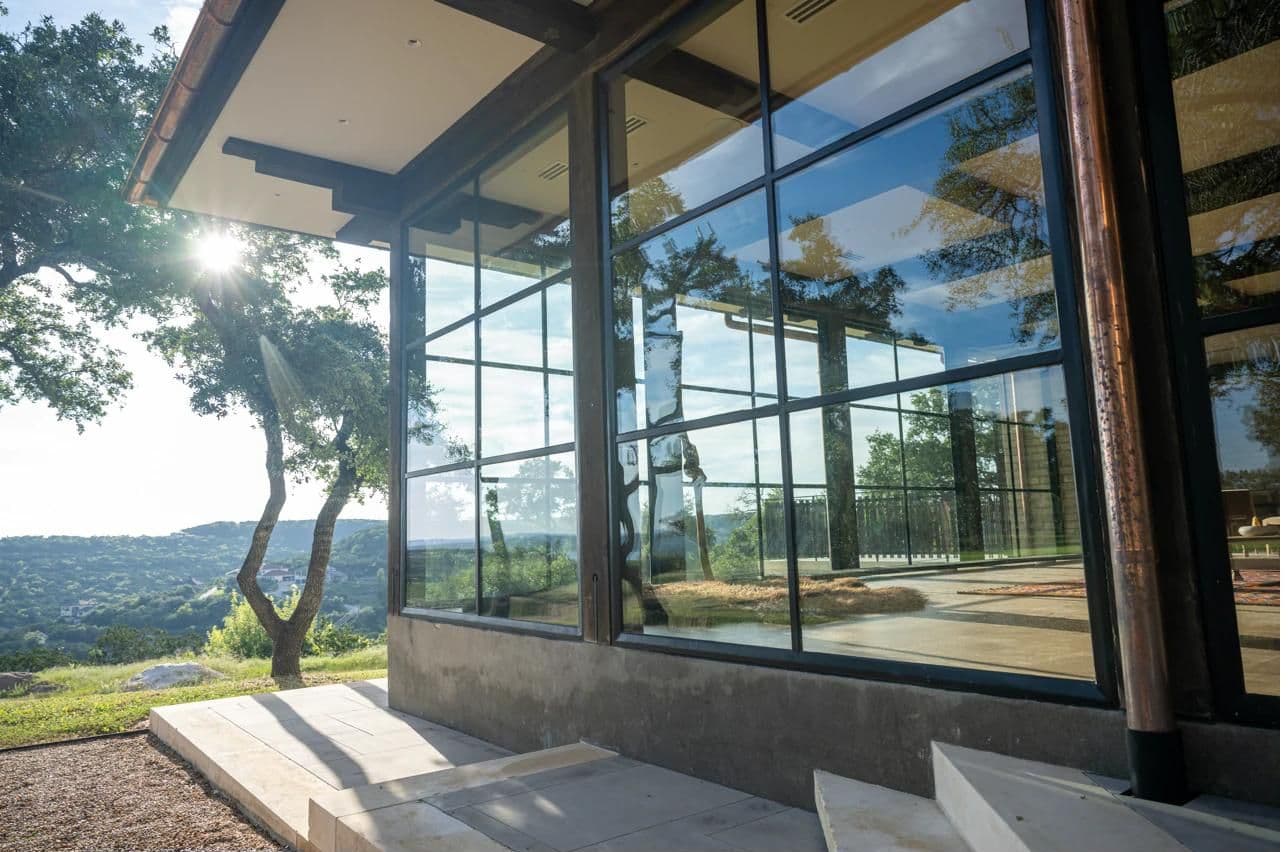 Luna Manor glass windows with sun flare over the Hill Country