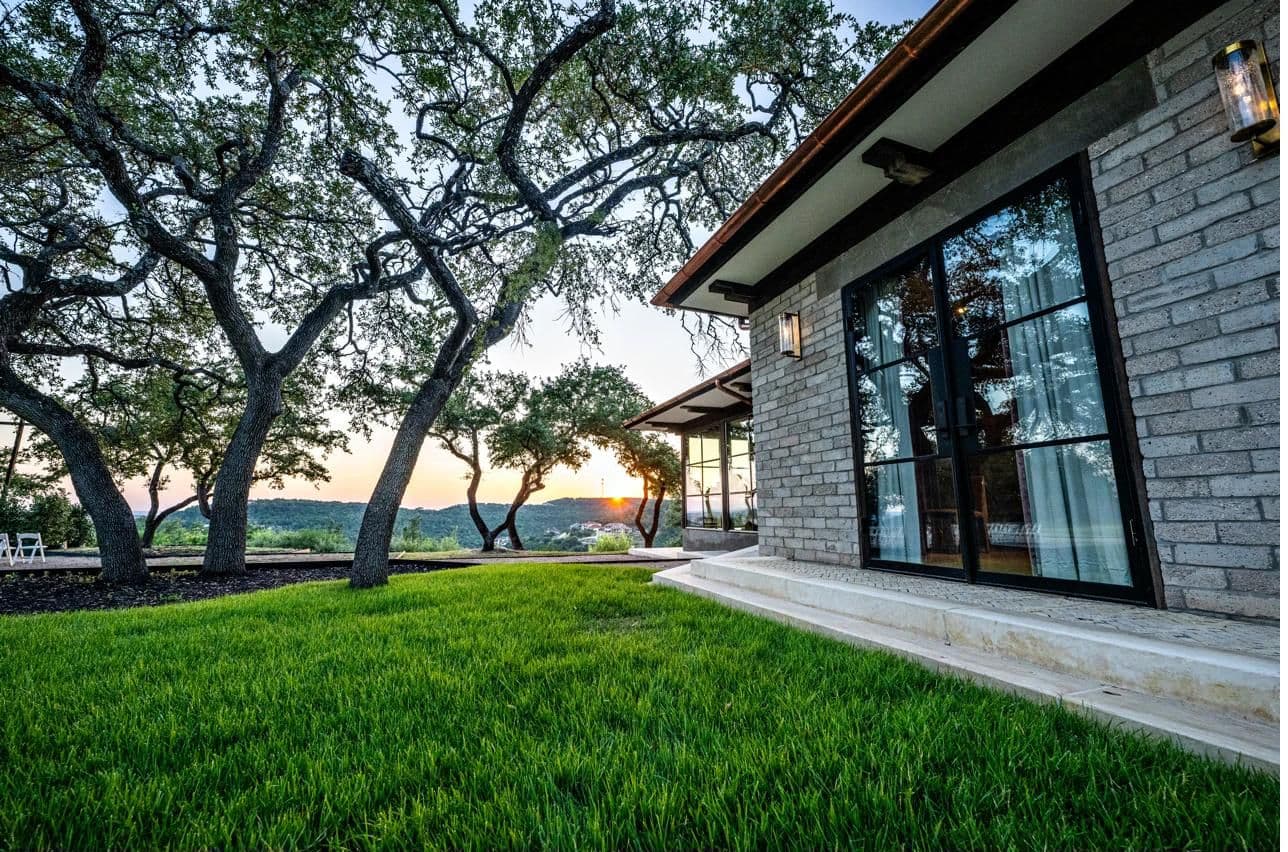 Luna Manor at sunset, seen through ancient oak trees