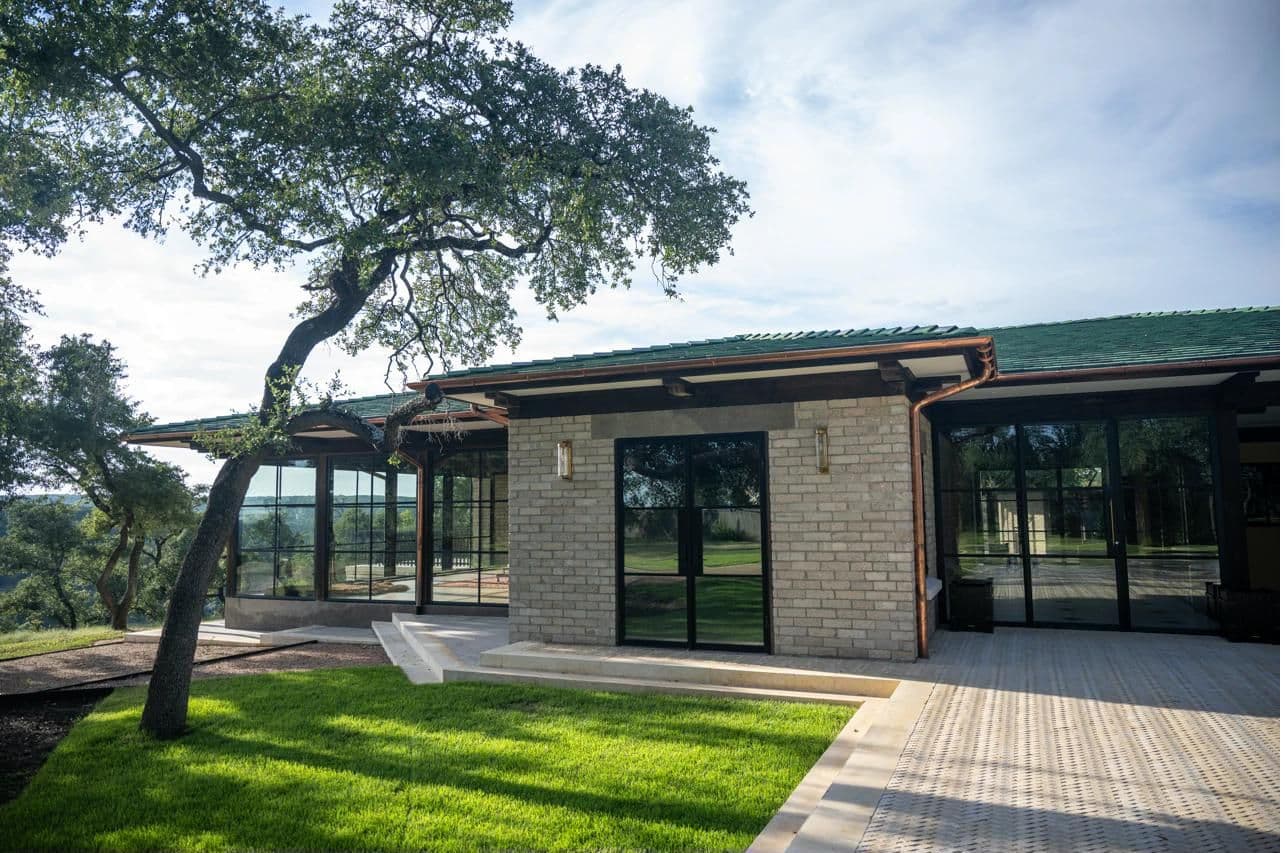 The Pavilion at dusk with glowing fire bowls at the entry