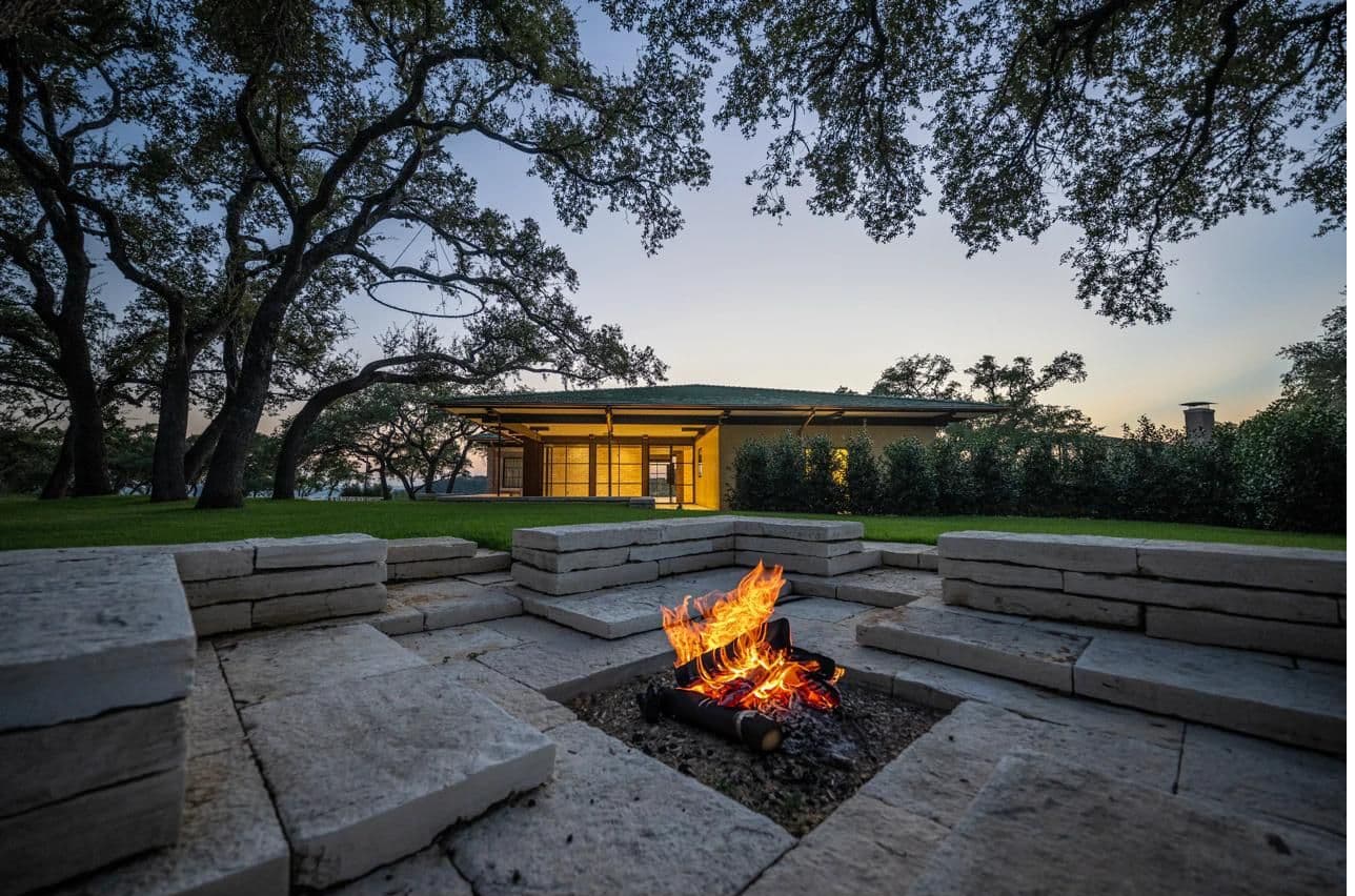 The Veranda fire pit with stone seating at dusk — cocktail hour